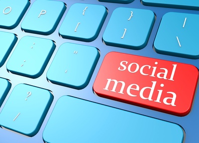 Ausschnitt einer Tastatur in Blautönen, statt der Enter-Taste sieht man eine rote Taste mit der Aufschrift „Social Media“